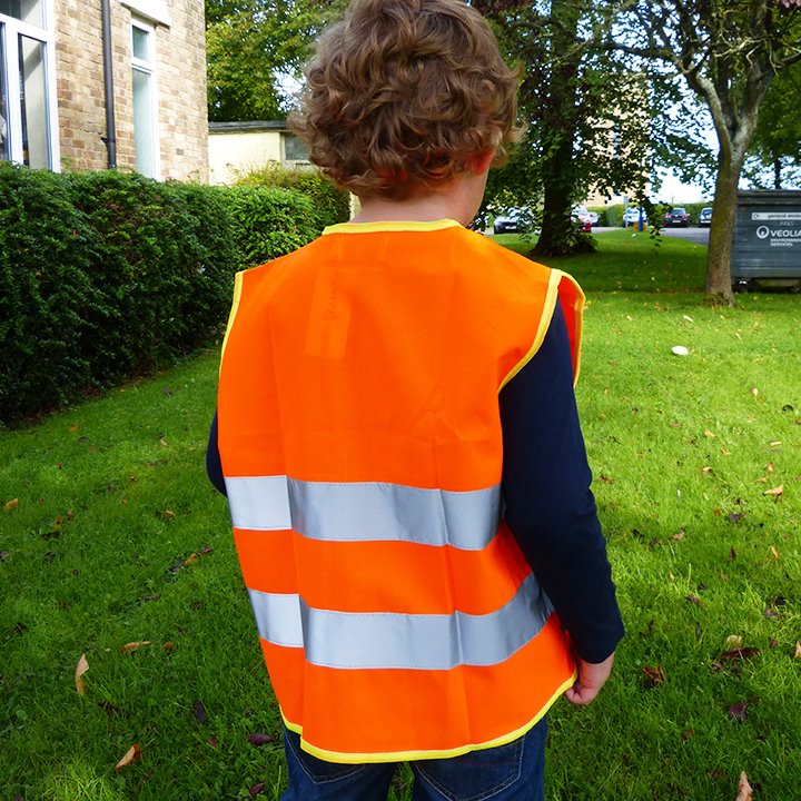 Boy wearing orange high vis vest
